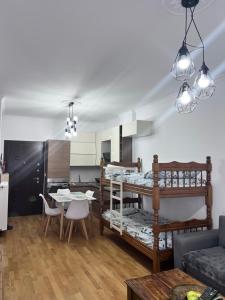 a living room with a loft bed and a kitchen at Seaview Apartments Right at The Beach in Durrës