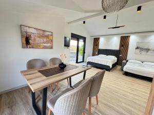 a living room with a dining table and a bedroom at Apartments Lj in Ulcinj