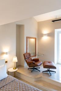 a bedroom with a bed and two chairs and a mirror at Dimora Cardinal Moroni in Rome +86 photos