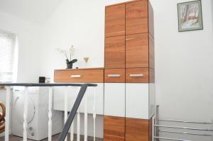 a tall wooden cabinet next to a desk in a room at Haus Lena in Cloppenburg