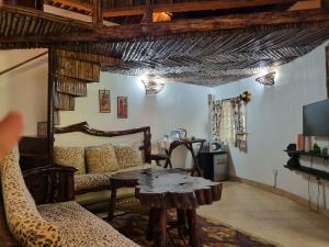 a living room with a table and a couch at Karen Little Paradise, ECO Garden Hotel & Farm in Nairobi +111 photos
