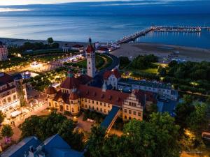 an aerial view of the city of brasov at night at SeaSide Sopot - butikowe noclegi przy plaży in Sopot