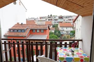 a balcony with a table and a view of a city at Rooftop rooms Ohrid in Ohrid