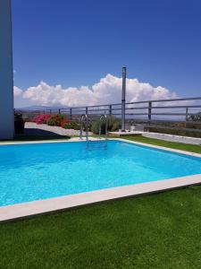 a large swimming pool on the side of a house at Villa P3 Paradise in Arménoi