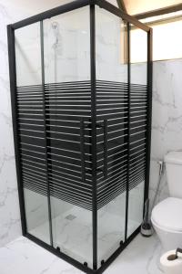 a glass shower in a bathroom with a toilet at New Rafi Hotel in Amman