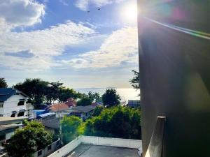 a view from the roof of a building with the sun shining at Exclusive condo & Seaview in Ban Bang Saen (1)