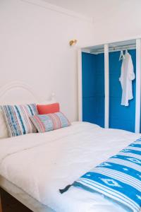 a bedroom with a bed with a blue headboard at Just Like Home - Quinta do Sinal 22 in Caminha