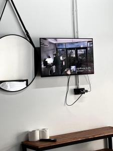 a mirror and a lamp and a tv on a wall at Sleep Owl Jomtien in Jomtien Beach +17 photos