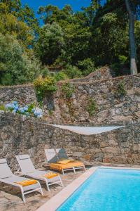 a swimming pool with lounge chairs and a swimming pool at Just Like Home - Quinta do Sinal 22 in Caminha