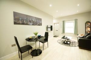 a living room with a table and a couch at Elm House in Reading