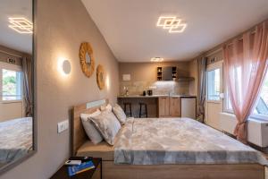 a small bedroom with a bed and a kitchen at Avli Home in Neos Marmaras