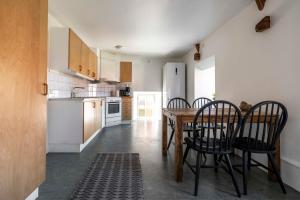a kitchen and dining room with a table and chairs at Charming penthouse in the center of Visby in Visby +8 photos
