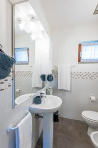 a white bathroom with a sink and a mirror at Le Ortensie in Arezzo +10 photos