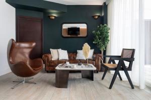 a living room with a couch and a table at Apartamentos Sevilla Centro in Seville