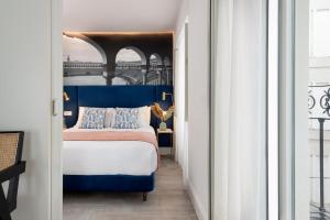 a bedroom with a blue and white bed in a room at Apartamentos Sevilla Centro in Seville