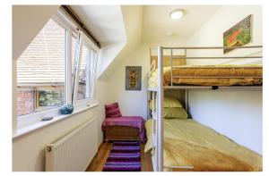a small room with bunk beds and a window at Sleeps10 18-Parking-Garden-Pool-HotTub-Balcony in Eastbourne +29 photos