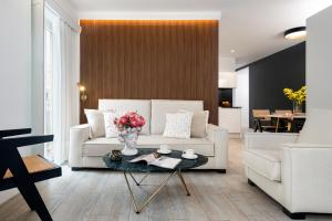 a living room with a white couch and a table at Apartamentos Sevilla Centro in Seville +37 photos
