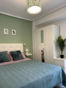 a bedroom with a large bed and a potted plant at Sea view apartment, first line on the beach, Remote work in Canet de Berenguer