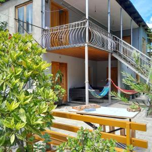 a house with a balcony with hammocks on it at Guesthouse Sumaisha in Gulida