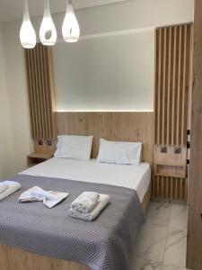 a bedroom with a bed with towels on it at Marinas House 2 in Skála Nikíta