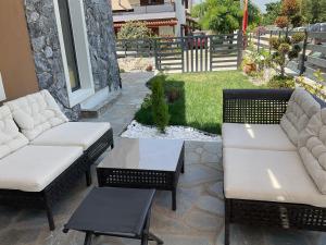a patio with two couches and a table at Marinas House 2 in Skála Nikíta