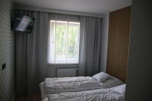 Postel nebo postele na pokoji v ubytování Apartament ARS Platinium Wisła-Spokojna