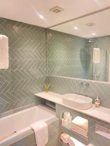 a bathroom with a white tub and a sink at Lilac Lodge - Strandhill Beach House in Strandhill +23 photos