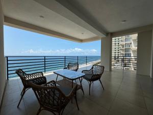 a balcony with a table and chairs and a view of the ocean at resting gonio in Gonio