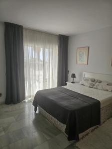 a bedroom with a large bed and a large window at Apartament - dom, Hiszpania Andaluzja, Costa del Sol in Estepona +28 photos
