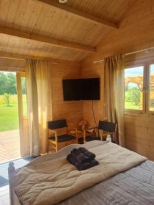 a bedroom with a bed and a flat screen tv at Jootme-Andruse Puhkemaja in Kuressaare