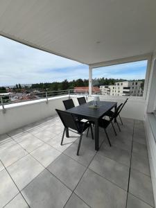 a black table and chairs on a balcony at rs44 Apartments über den Dächern von Bregenz in Bregenz