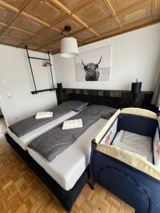 two beds in a room with a bull head on the wall at rs44 Apartments über den Dächern von Bregenz in Bregenz