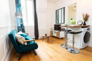 a living room with a green chair and a table at Cozy studio in Clamart Near Paris attractions in Clamart
