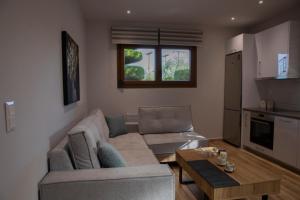 a living room with a couch and a table at Apartment Viewing Garden in Volos