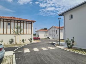 an empty street in a town with buildings at Maison Marsane côte Landaise in Lit-et-Mixe