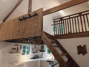 a staircase in a house with wooden beams at Helmina's Villas in General Luna