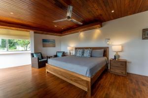 a bedroom with a bed and a wooden ceiling at Casa Brisas Del Mar- Luxury 6 Bedroom Ocean View Home in Puerto Viejo +32 photos