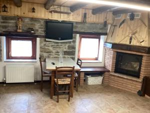 a dining room with a table and a fireplace at Casa Scarbini in Savogna
