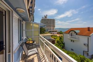 a balcony with a view of a building at PODVEZANEC in Dramalj