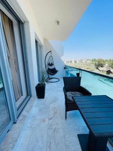 a balcony with a view of a swimming pool at Amely Apartments 305 by Wave Residence in Mamaia Nord