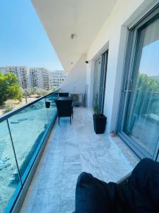 a balcony with a view of the water in a building at Amely Apartments 305 by Wave Residence in Mamaia Nord +15 photos