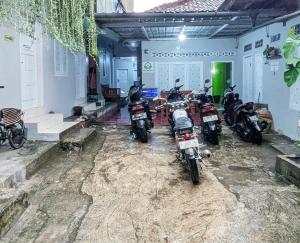 a group of motorcycles parked in a garage at Kosan Syariah Mas Slamet in Tasikmalaya