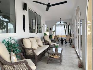 a living room with a couch and chairs and a table at Casa Tia, Mojácar with Private Pool and less than 5 minutes from beach! in Mojácar