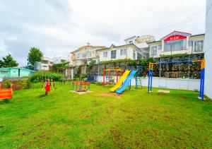 a playground with a slide in a yard at Kodai Outdoor Valley in Kodaikānāl