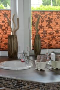 a bathroom counter with a sink and a mirror at Ferienwohnung im Sonnenberg in Enkirch