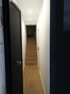 an open door to a hallway with a staircase at Habitación Sa Palomera con baño privado a 2 min del mar in Blanes