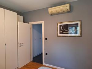 a room with a air conditioner on the wall at Apartment Vidak in Labin +8 photos