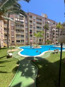 a large apartment building with a large swimming pool at Magdalena Apartament in Torrevieja