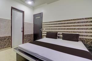 a bed in a room with a brick wall at Collection O The Legend Hotel, Hisar in Hisār
