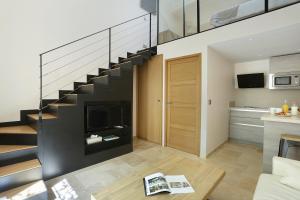 a living room with a staircase in a house at Les Maisons Du Sud in Saint-Tropez